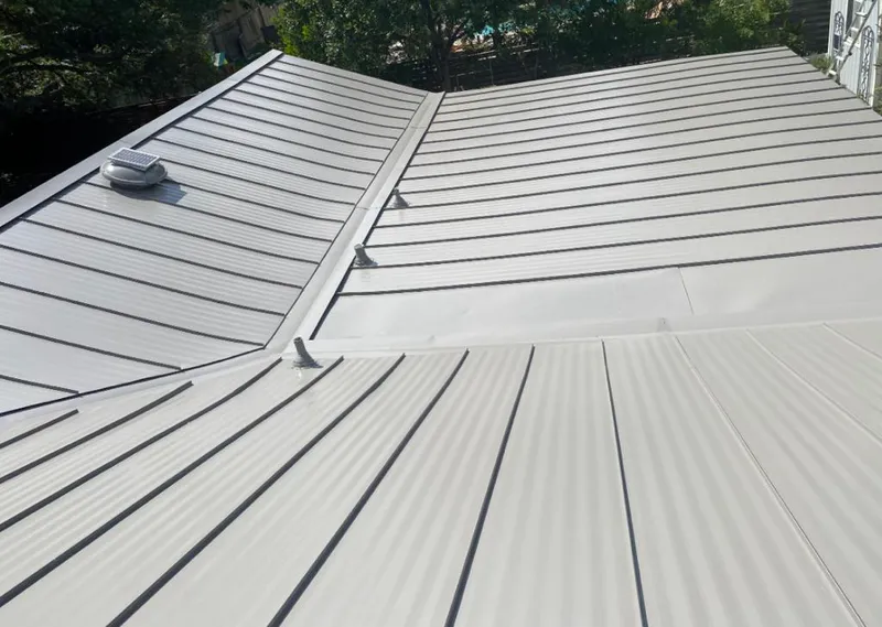 Solar attic fan installed on a metal roof for Roof Ventilation in Moon